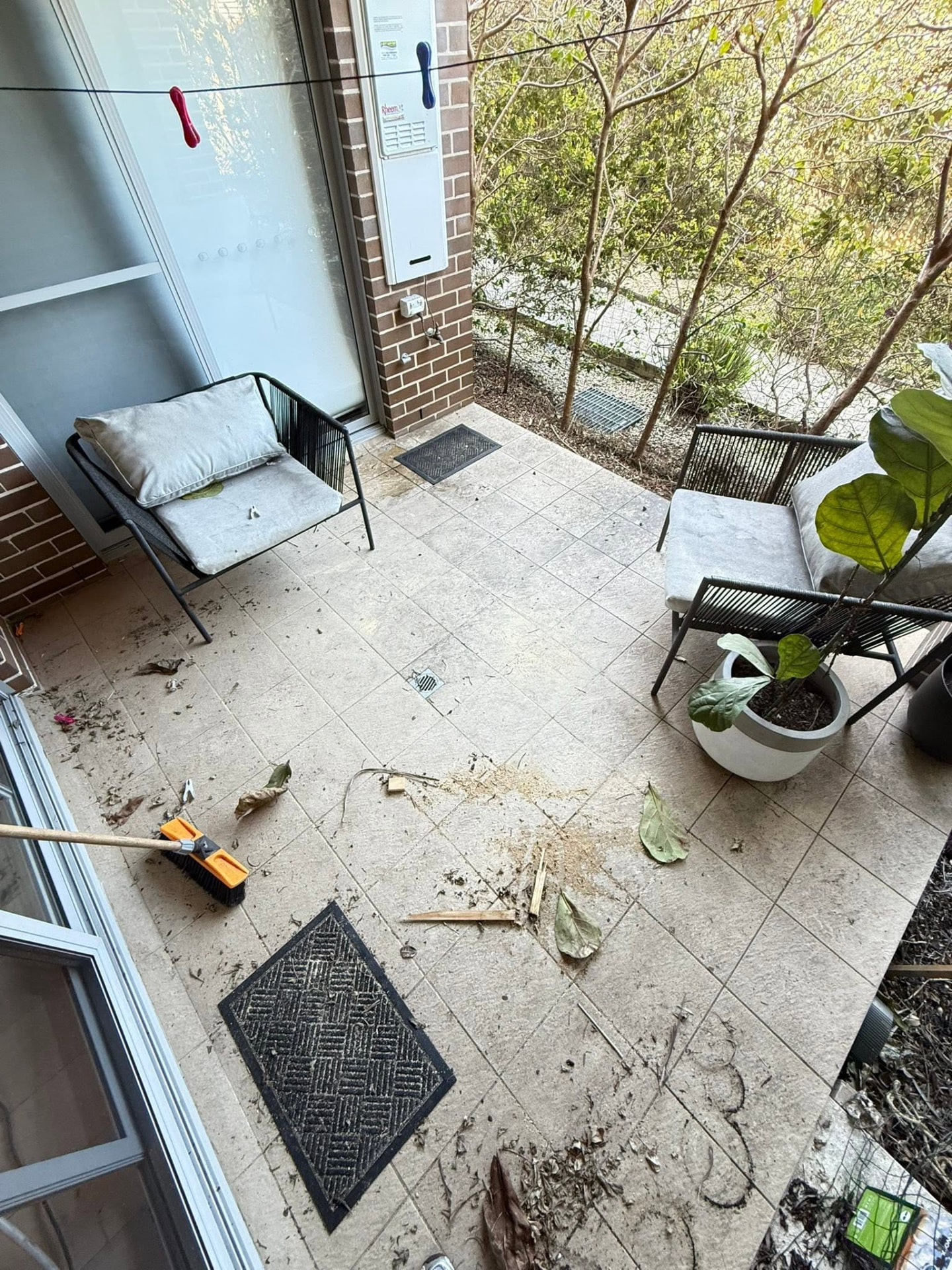 Dirty courtyard patio tiles before Jetmate cleaning