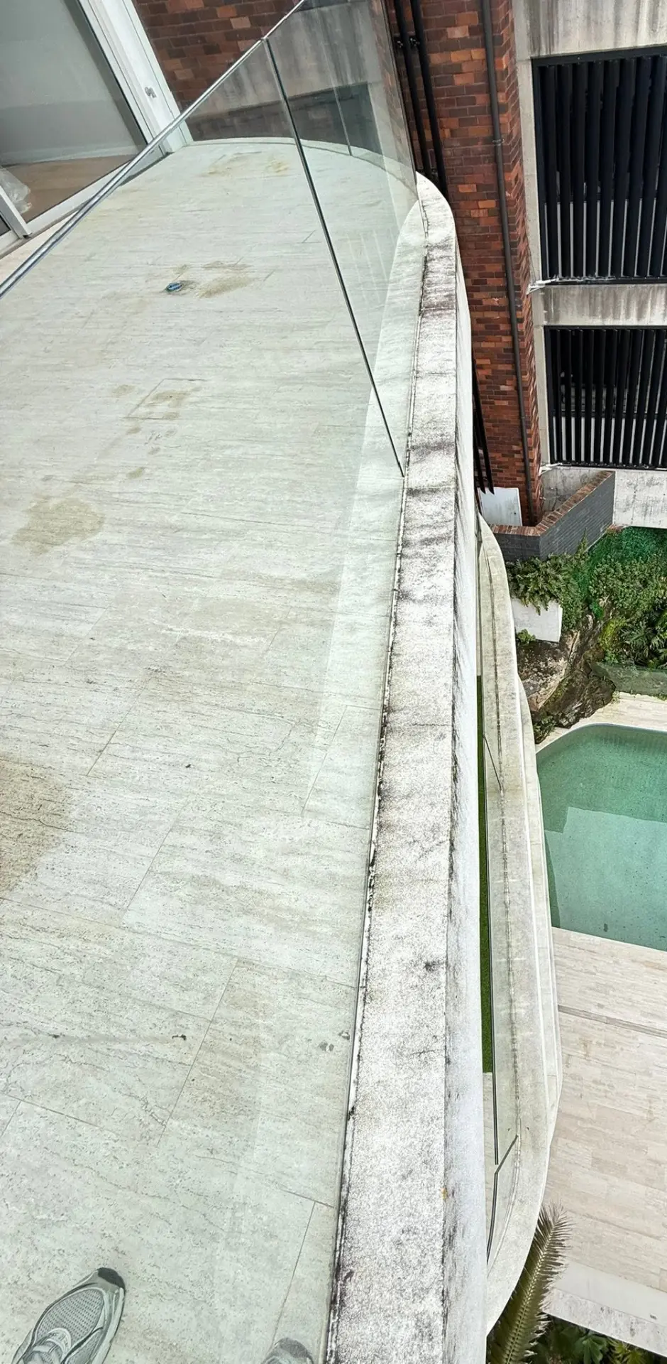 Balcony and pool surround before Jetmate pressure cleaning